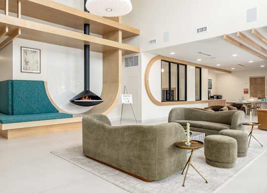 A modern living room with a fireplace and comfortable seating.