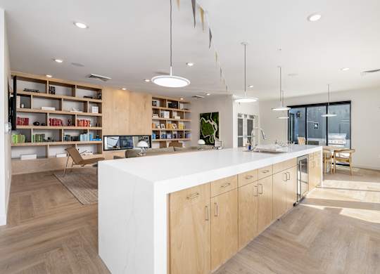 A modern kitchen with wooden cabinets and a white island.