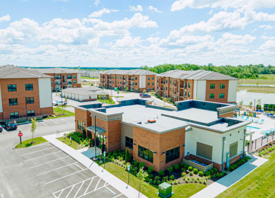 an aerial view of an apartment complex with a parking lot