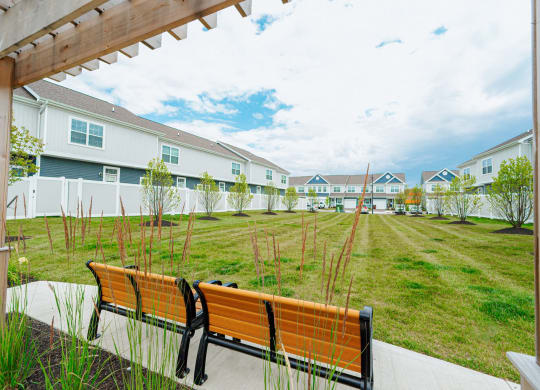 a group of benches in front of some houses