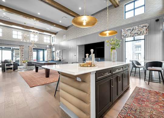 A modern kitchen with a large island and a dining area.