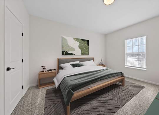 A bedroom with a large bed and a painting on the wall.