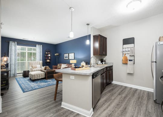 our apartments offer a kitchen and living room with a blue accent wall
