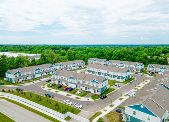 an aerial view of a group of houses in a parking lot
