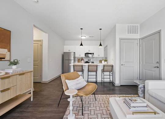 A modern kitchen with a dining table and chairs.