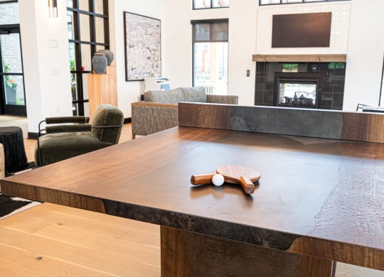 a large communal table in a living room with a fireplace