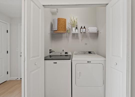 A small laundry room with a washer and dryer.