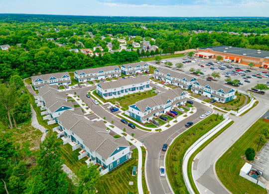 an aerial view of a group of houses and a parking lot