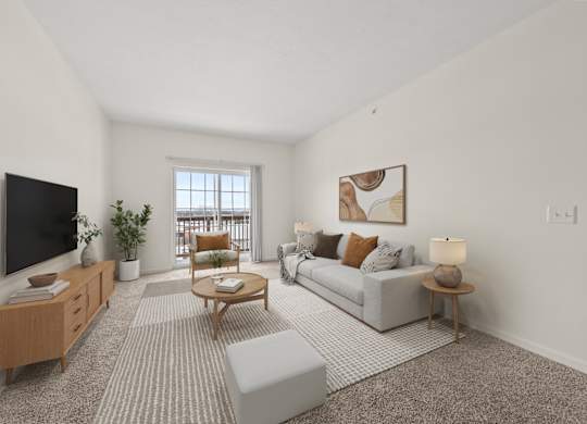 A living room with a grey couch, a wooden coffee table, and a flat screen TV mounted on the wall.