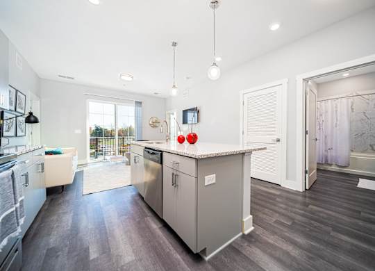 a kitchen with an island and a door to a bathroom