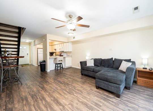 a living room with a couch and a ceiling fan