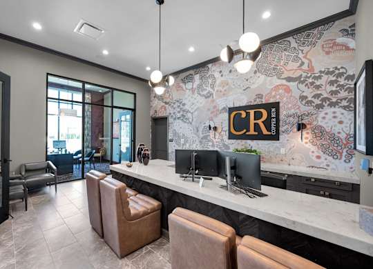 A reception area with a counter and chairs.