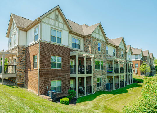 a large brick house with a yard in front of it