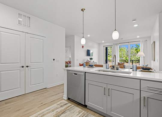 A modern kitchen with white cabinets and a large island.
