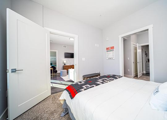 a bedroom with a bed and a door to a bathroom