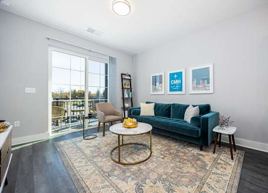 a living room with a blue couch and a window