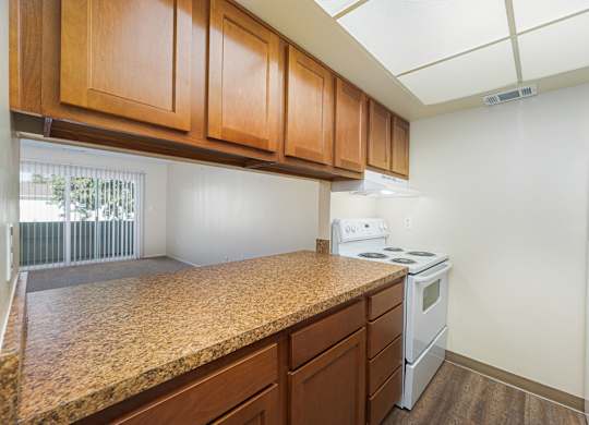 a kitchen with a granite counter top and white appliances