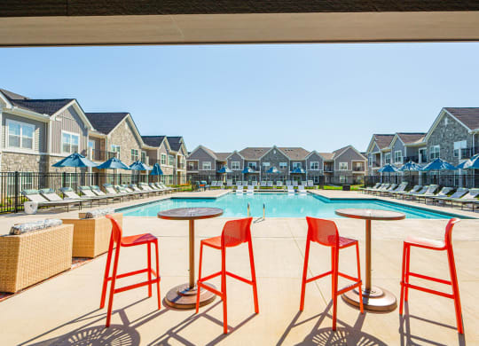 our apartments have a resort style pool with red bar stools