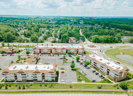 an aerial view of an apartment complex and parking lot