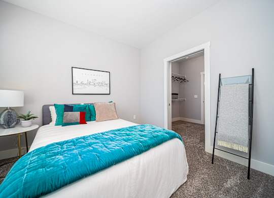 a bedroom with a bed and a mirror