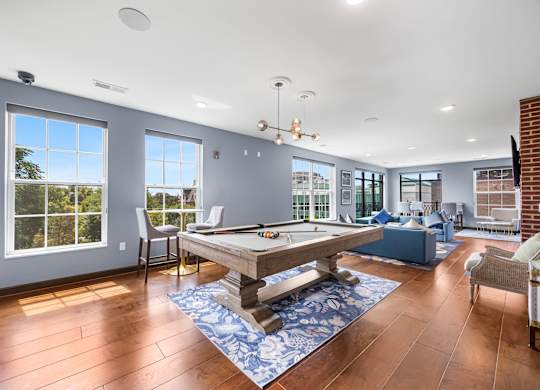 A room with a pool table and a view of the outside.