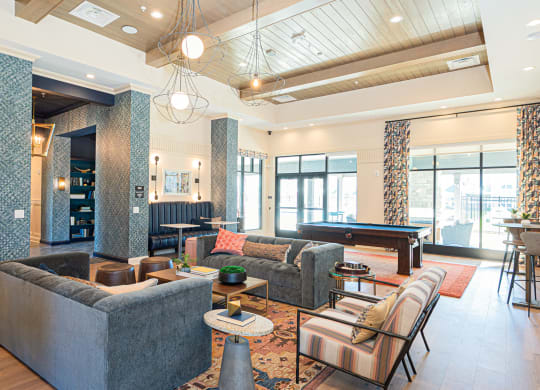 a clubhouse with couches and a pool table