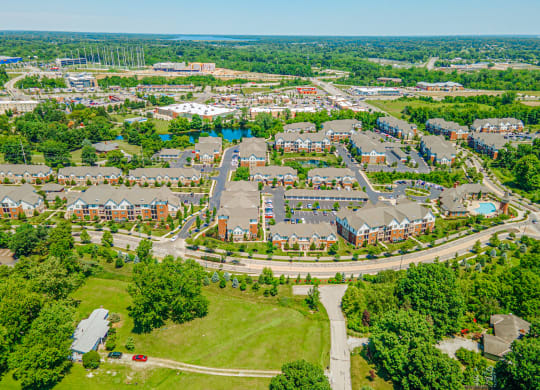 an aerial view of a neighborhood with houses and a road