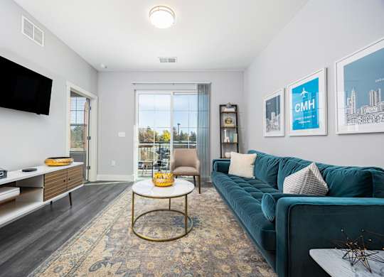 a living room with a blue couch and a television
