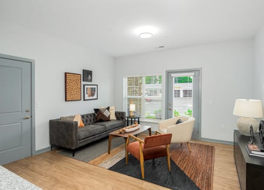 a living room with a couch and a chair and a table