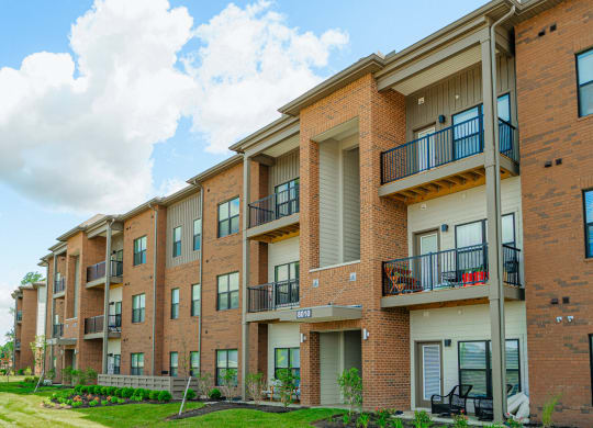the outlook of a brick apartment building with balconies