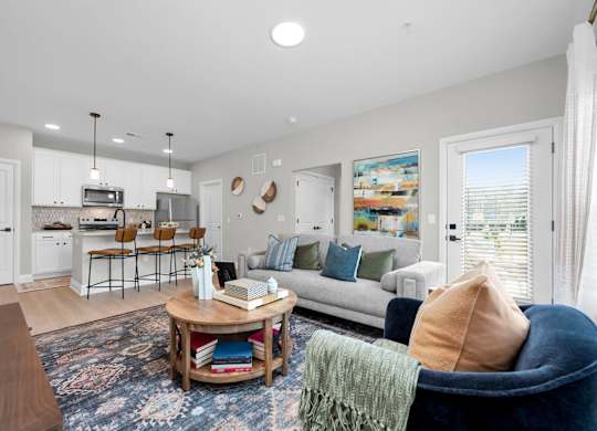 A living room with a white couch and a coffee table.