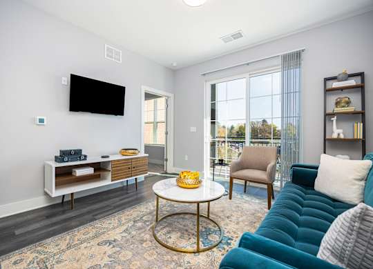 a living room with a blue couch and a table