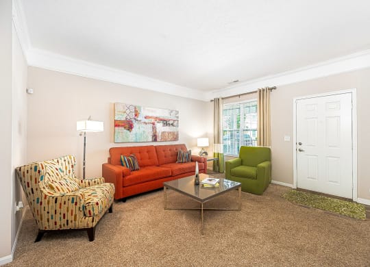 a living room with a couch and chairs and a table