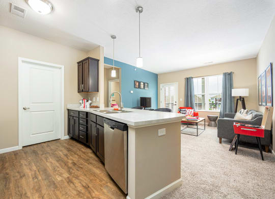 a kitchen and living room with a couch and a table