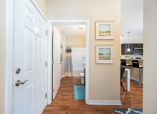 a hallway with a door to a kitchen and a living room