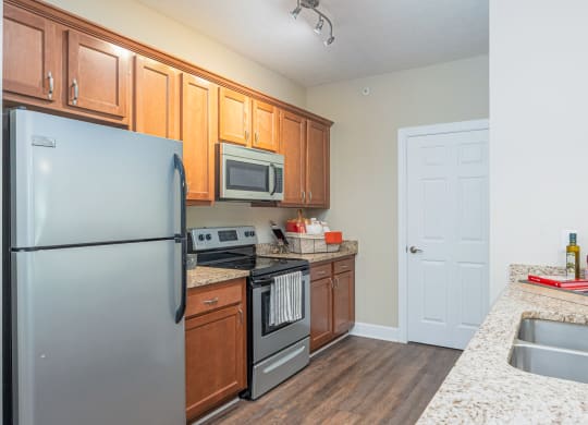 a kitchen with stainless steel appliances and granite counter tops