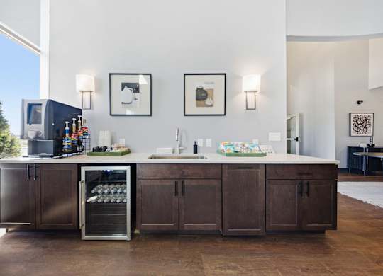 A kitchen with a refrigerator, cabinets, and a countertop.