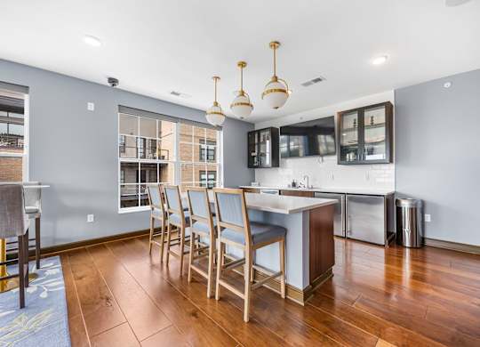 A kitchen with a dining table and chairs.