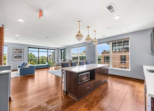 A modern kitchen with a wooden island and stainless steel appliances.