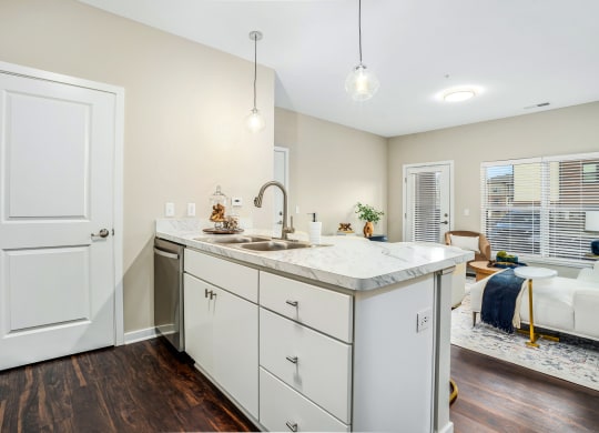 a renovated kitchen with white cabinets and a counter top