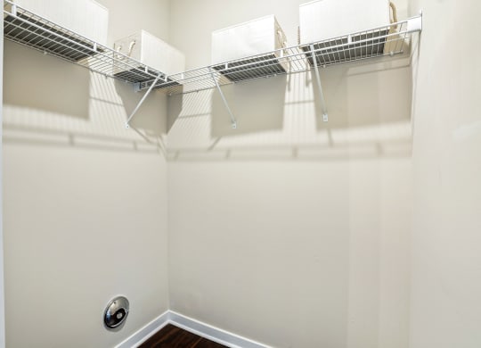 the spacious walk in closet in the master bedroom of a home with a mirrored wall