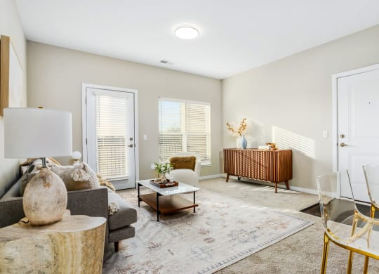 a living room with a couch and chairs and a table