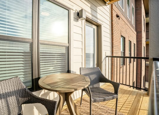 a patio with chairs and a table on a balcony