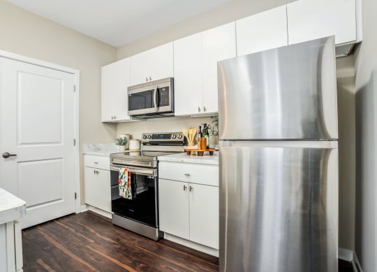 a kitchen with stainless steel appliances and white cabinets