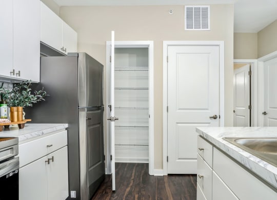 a renovated kitchen with white cabinets and stainless steel appliances