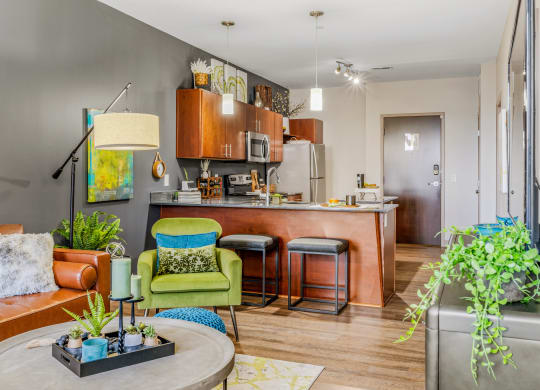 a living room with a kitchen in the background