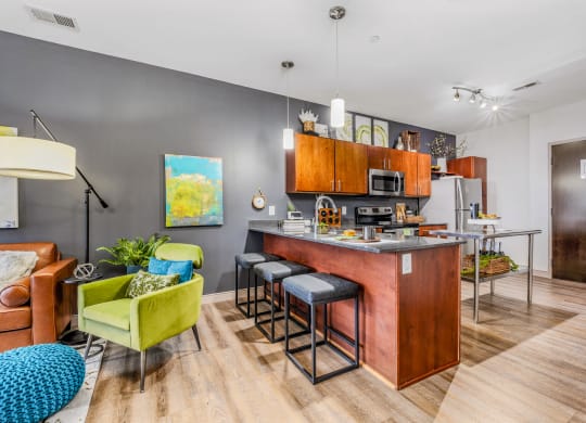 a kitchen with a bar and a living room with a couch