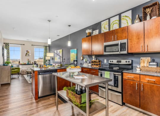 a large kitchen with stainless steel appliances and wooden cabinets