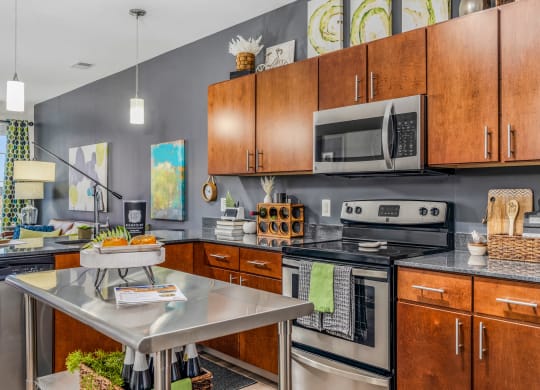 a kitchen with stainless steel appliances and wooden cabinets