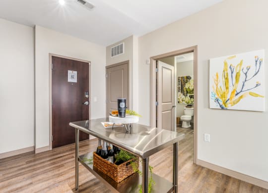 a kitchen with a table and a door to a bathroom